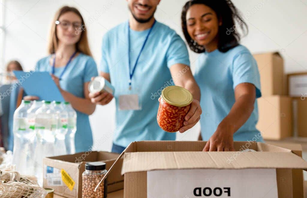 Volunteers sorting food donations at a community charity drive